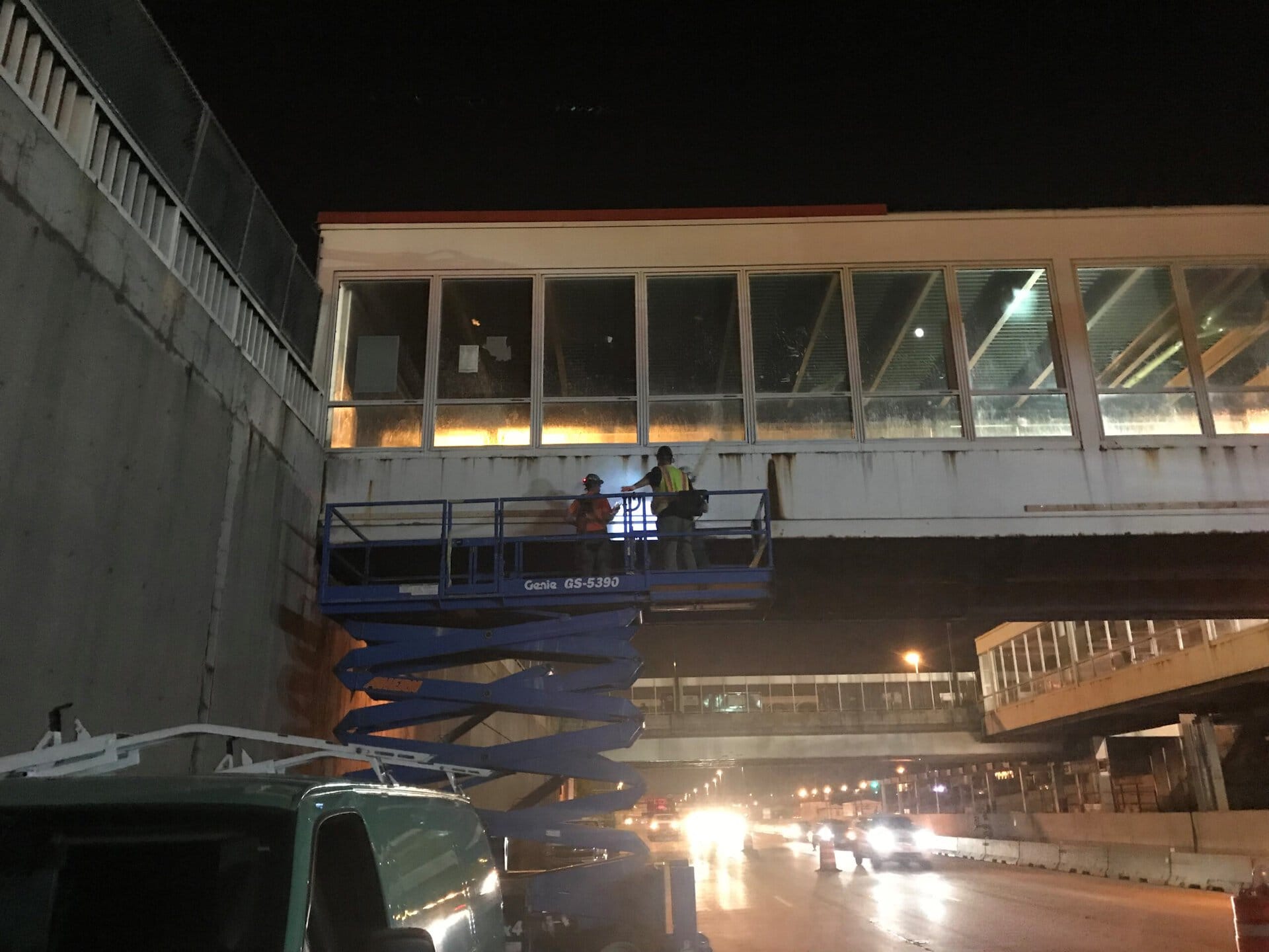 Two men in safety gear are working on a construction site.